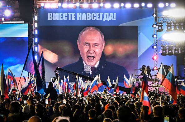 Russian President Vladimir Putin is seen on a screen set at Red Square as he addresses a rally and a concert marking the annexation of four regions of Ukraine Russian troops occupy - Lugansk, Donetsk, Kherson and Zaporizhzhia, in central Moscow on September 30, 2022. 